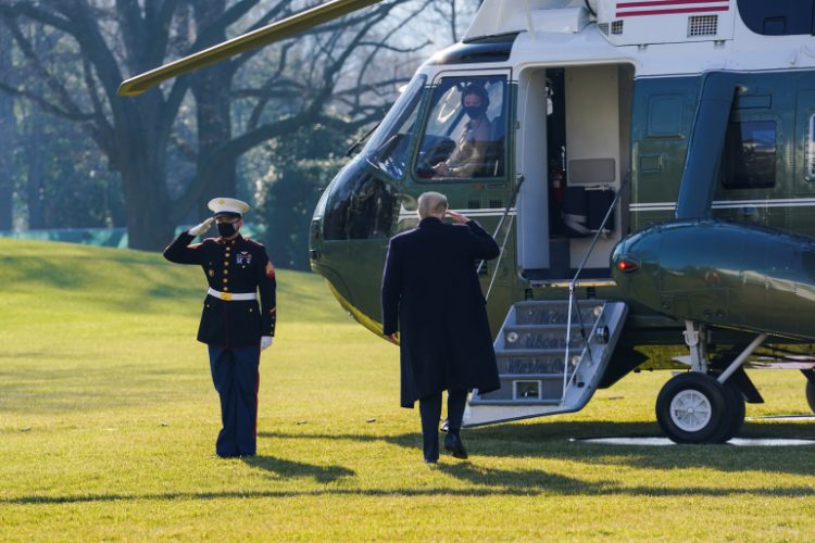 FILE PHOTO: U.S. President Donald Trump boards Marine One as he departs the White House on travel to visit the U.S.-Mexico border Wall in Texas, in Washington, U.S., January 12, 2021. REUTERS/Kevin Lamarque/File Photo