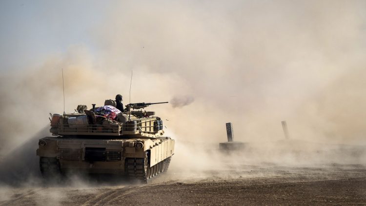 Dust rises as a tank from the Iraqi army's 9th armoured division fires at a suspect car approaching their position in the area of Ali Rash, adjacent to the eastern Al-Intissar neighbourhood of Mosul, on November 6, 2016, during a military operation to retake the main hub city from the Islamic State (IS) group jihadists.  
Iraqi forces battled jihadists inside Mosul for the third day running while civilians risked their lives dodging bombs and snipers to slip out of the city. / AFP / Odd ANDERSEN / ALTERNATIVE CROP        (Photo credit should read ODD ANDERSEN/AFP/Getty Images)