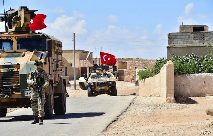 A handout picture realeased by the Turkish Armed Forces shows Turkish soldiers accompanied by armoured vehicles patrolling between the city of Manbij in northern Syria and an area it controls after a 2016-2017 military incursion on June 18, 2018. - Turkey said it had started military patrols in an area around the Kurdish-held city of Manbij, in line with an agreement with the United States to scale down tensions in the region. (Photo by Handout / TURKISH ARMED FORCES / AFP) / XGTY / == RESTRICTED TO EDITORIAL USE - MANDATORY CREDIT "AFP PHOTO / HO / TURKISH ARMED FORCES" - NO MARKETING NO ADVERTISING CAMPAIGNS - DISTRIBUTED AS A SERVICE TO CLIENTS ==